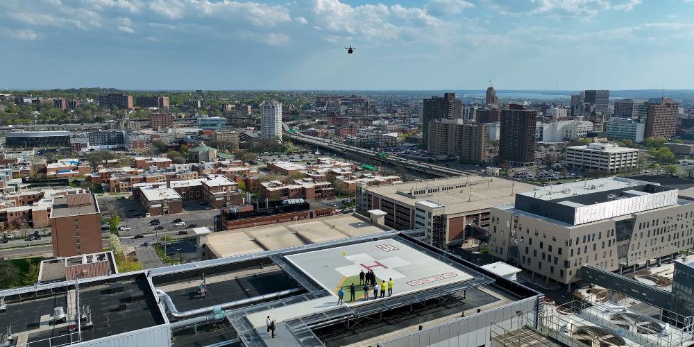 Drone delivery to the Chancellor over the Syracuse skyline