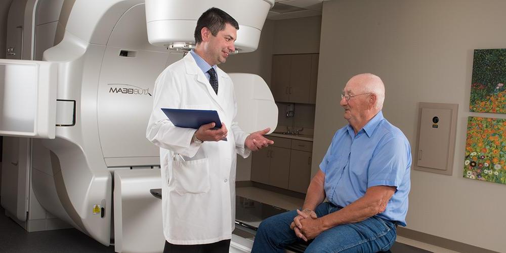 Doctor and patient in front of true beam radiation machine
